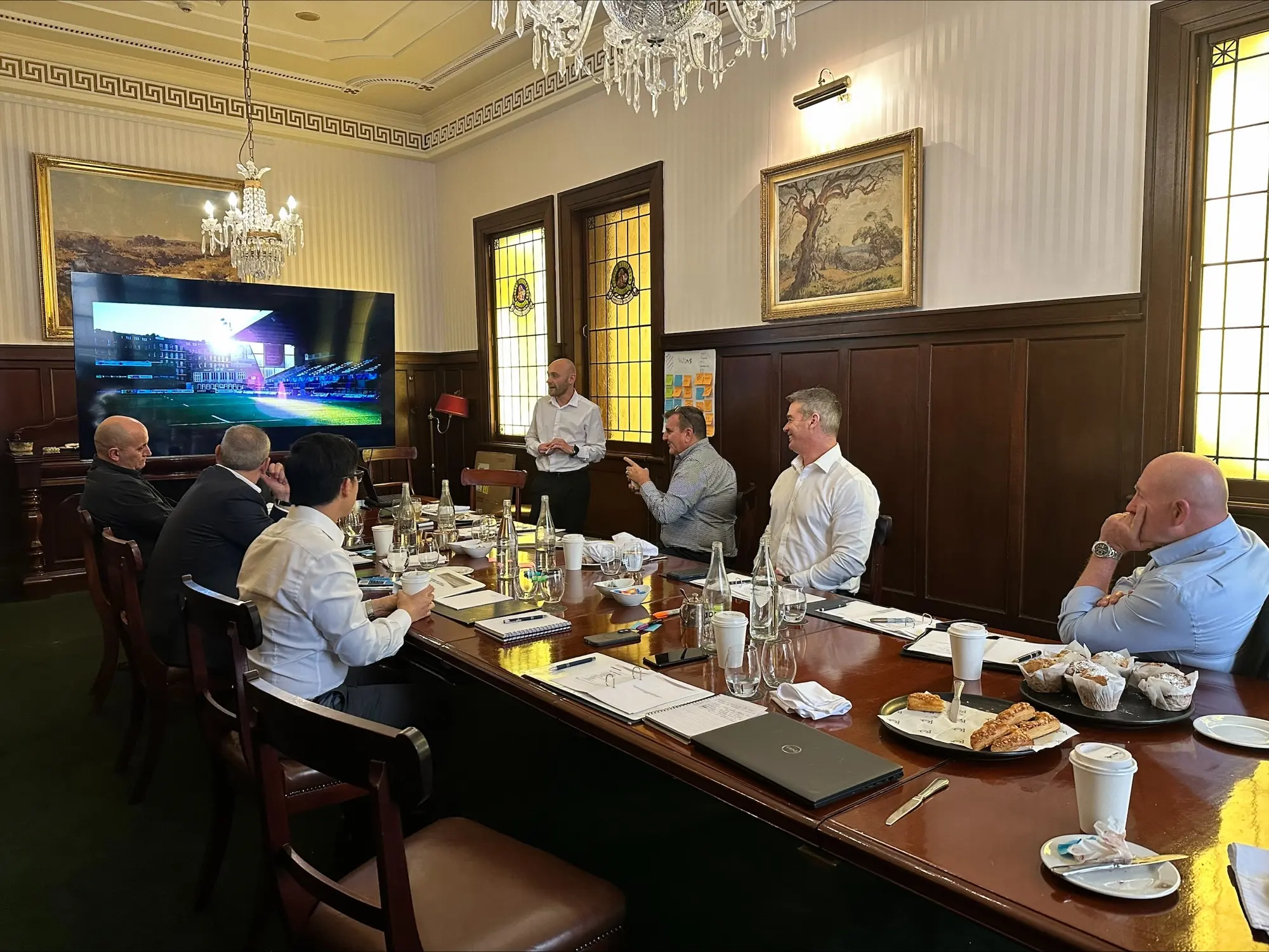 Steve Morris presenting to executives in a boardroom leadership session