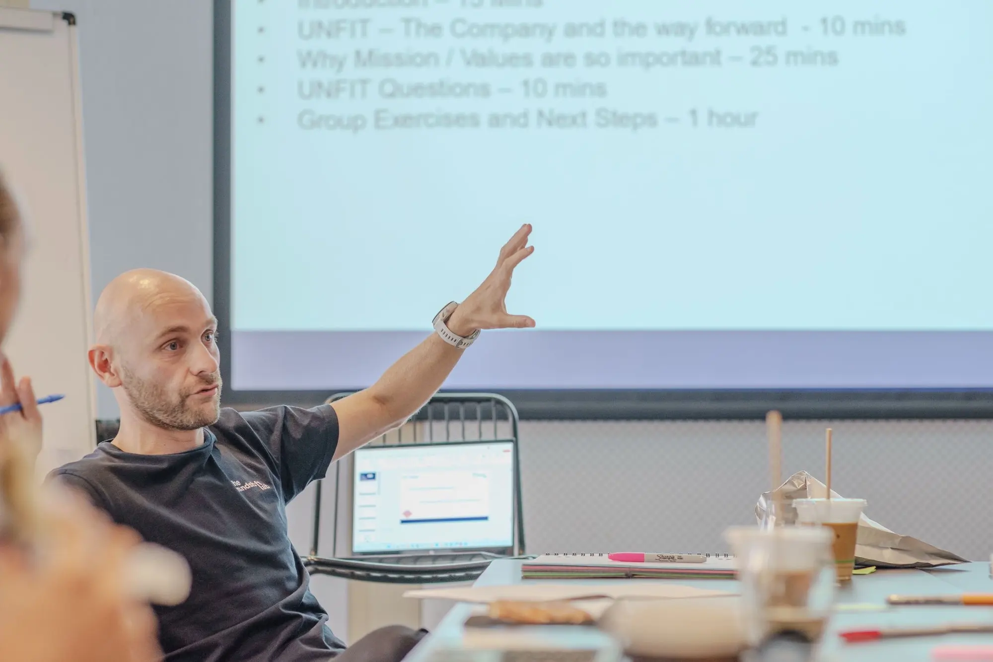 Steve Morris leading a values workshop, seated and gesturing as he makes a point to the group
